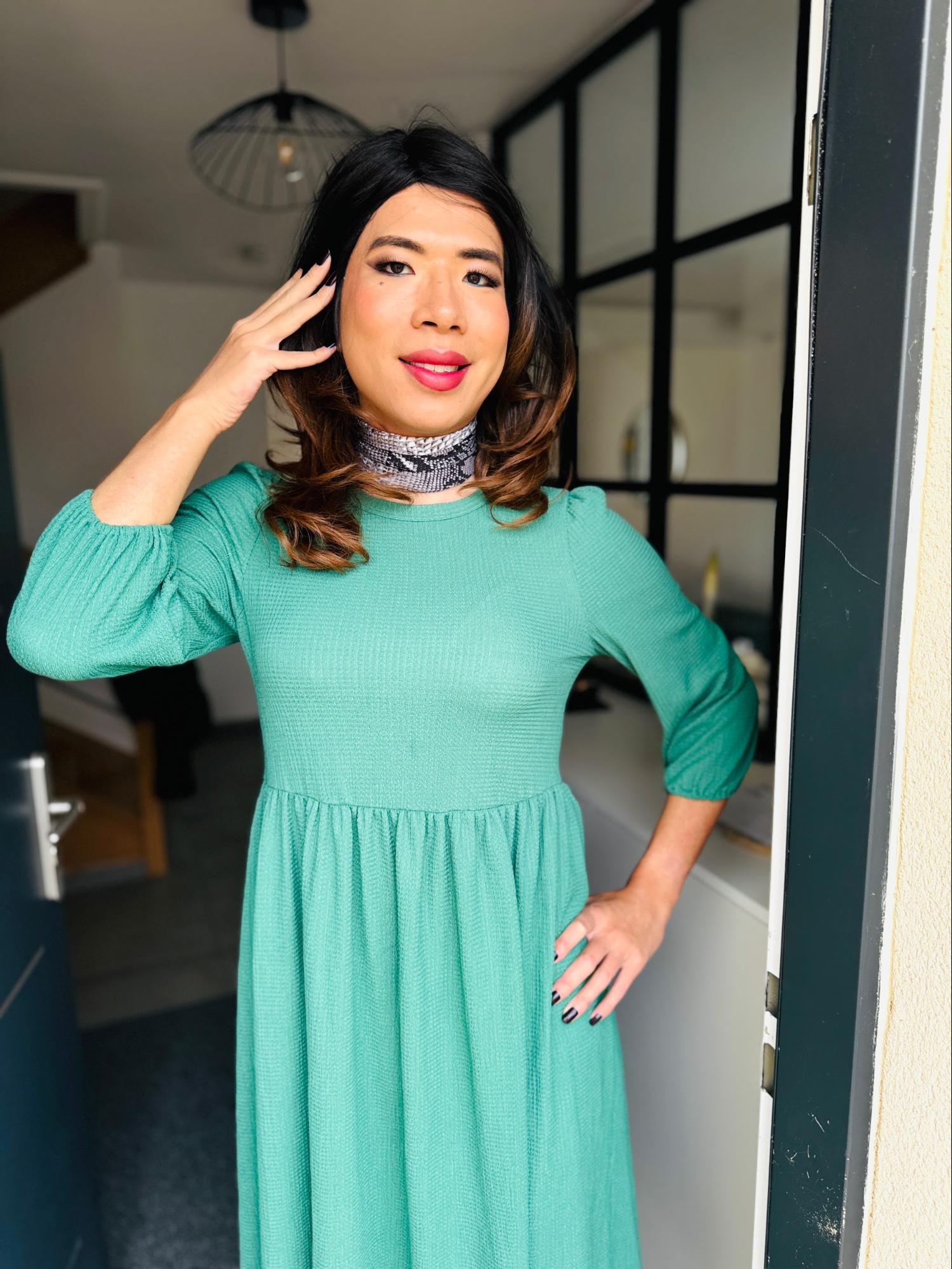 Sarah pose en robe verte après sa séance de maquillage Transbeauté, avant de raconter sa première sortie shopping et son chemin vers plus de confiance.